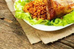 Delicious dishes from chicken thigh with rice and salad leaves photo