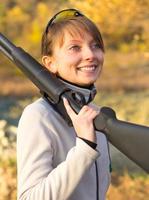 Young beautiful girl with a shotgun photo