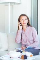 Businesswoman talking on the cellphone in a coffee house photo