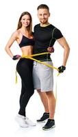 contento atlético Pareja - hombre y mujer con medición cinta en el blanco foto