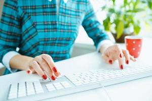 Woman office worker typing on the keyboard photo