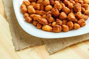 Cookies on a white plate on a sacking on a wooden background photo