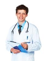 Portrait of smiling  young male doctor writing on a patient's medical chart on white photo