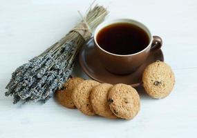 Lavender, cookies and cup of tea on white wooden background photo