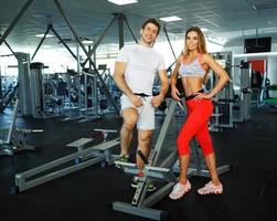 Athletic man and woman after fitness exercise in gym photo