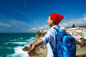 Woman with a backpack behind her back is spinning her arms out to the sides photo