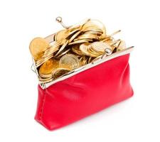 Red purse full of gold coins on a white photo