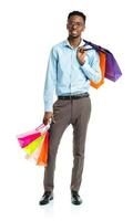 Happy african american man holding shopping bags on white background photo