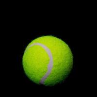 Tennis ball on black background photo