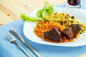 Dish of roast beef with rice and salad leaves photo