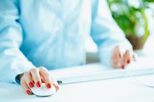 Woman office worker typing on the keyboard photo