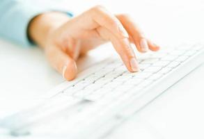 Woman office worker typing on the keyboard photo