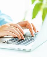 Woman office worker typing on the keyboard photo