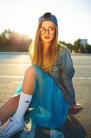 Young modern woman with skateboard photo