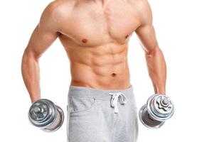 Sport man with dumbbells on the white photo