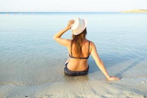 Young woman having fun at the beach photo