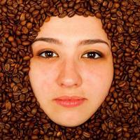 Coffee beans around of face photo