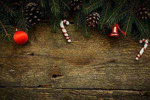 Christmas tree branches with christmas decorations on wooden texture photo