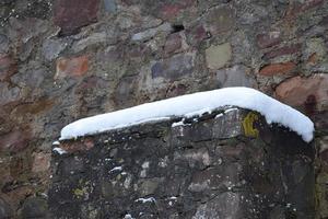 snow on a ruin wall, medieval castle remains photo