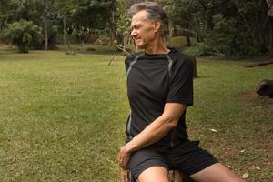 Mature Man outside at a local park doing Stretches before working out photo