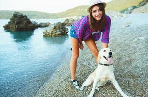 Woman with a dog on a walk on the beach photo