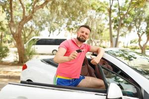 joven hombre con nuevo coche foto