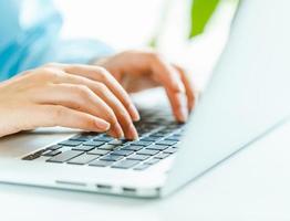 Woman office worker typing on the keyboard photo