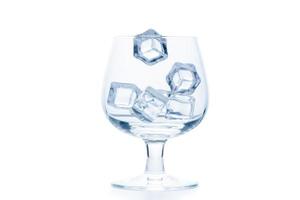 drop ice cubes in to empty Snifter or Balloon glass isolated photo