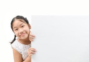 cute little girl holding a blank billboard isolated on white background, photo