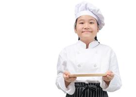 Portrait of a professional girl chef holding an empty dish. Isolated on white background. photo