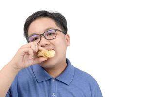 Obese fat boy eating potato chips isolated on white background, photo