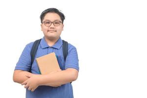 Obses boy student wearing a blue polo shirt wearing eyeglasses holding a notebook isolated photo