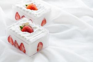 strawberry shortcake in plastic box on with cloth background and copy space, photo