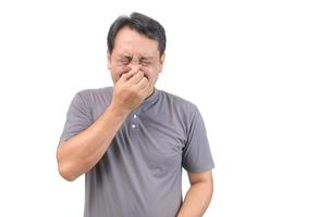 Man covers nose with hand, smells something awful photo