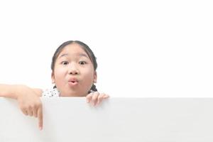 cute little girl pointing blank billboard isolated on white photo