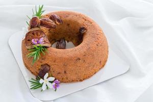 Date Cake and Decorate  with dried dates. dried quince and rosemary leaves photo