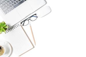 White office desk table, Blank notebook with laptop and black coffee. Top view with copy space, photo