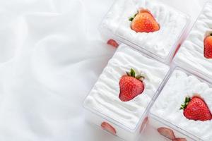 strawberry shortcake in plastic box on with cloth background and copy space, photo