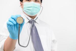 Young doctor holding stethoscope on white background. photo