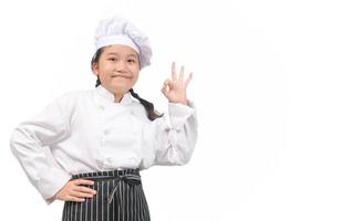 Smiling cute girl chef showing ok hand sign isolated on white background, photo