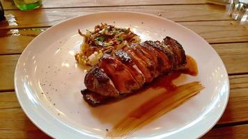 Baked duck on a white plate, sliced. photo