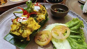 Famous traditional Cambodian Khmer delicacy, the Amok Fish. Vegetables and soya sauce. photo