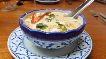 The most popular Asian soup is Tom Kha.The bowl is painted blue. photo