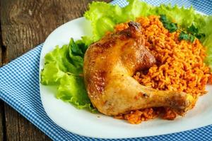 Delicious dishes from chicken thigh with rice and salad leaves photo