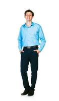 Happy young businessman standing with his hands in pockets on white photo