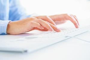 Female woman office worker typing on the keyboard photo