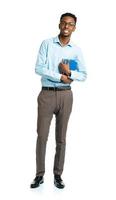 Happy african american college student with books in his hands standing on white photo