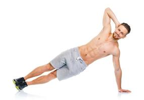 Sport attractive man doing fitness exercises on the white photo