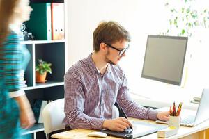 Young woman and man working from home - modern business concept photo