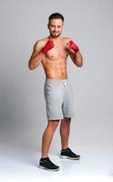 Athletic man wearing boxing bandages photo